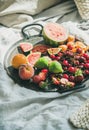 Tray full of fruit over light blanket background, copy space Royalty Free Stock Photo