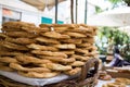 Tray full of Greek traditional round sesame bread rings, displayed in a street market with bokeh background Royalty Free Stock Photo