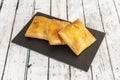 Tray of Galician empanadas varnished with egg yolk and stuffed with meat