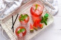 Tray with glasses and jug of tasty cold watermelon lemonade on white wooden table Royalty Free Stock Photo