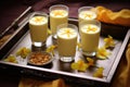 tray with glasses of mango lassi and flower petals Royalty Free Stock Photo