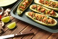 Tray with meat stuffed zucchini boats on wooden table, closeup Royalty Free Stock Photo