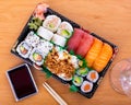 Tray with nigiri, uramaki and makizushi rolls with tuna, salmon, avocado and fried onions
