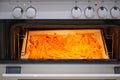 A tray of oven baked sweet potato chips in closeup. Sliced sweet potato in the the oven Royalty Free Stock Photo