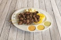 Tray of Peruvian anticuchos punctured on wooden sticks cooked on the barbecue with cooked corn, potatoes Royalty Free Stock Photo