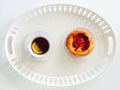 Tray with raspberry pastry and cup of tea