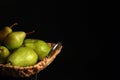 Tray with ripe pears on table against dark background Royalty Free Stock Photo