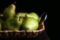 Tray with ripe pears on wooden table against dark background Royalty Free Stock Photo