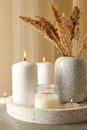 Tray with scented candles and reed on gray table Royalty Free Stock Photo