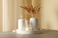 Tray with scented candles and reed on gray table Royalty Free Stock Photo