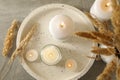 Tray with scented candles and reed on gray table Royalty Free Stock Photo