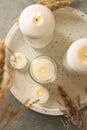 Tray with scented candles and reed on gray table Royalty Free Stock Photo