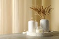 Tray with scented candles and reed on gray table Royalty Free Stock Photo