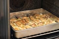 Tray with seasoned sliced king trumpet mushrooms pleurotus eryngii, potatoes and onions in the oven Royalty Free Stock Photo