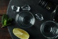 Tray with shots and bottle of vodka on wooden background Royalty Free Stock Photo