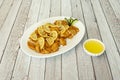 Tray of sliced breaded chicken breast fillets and Chinese recipe lemon juice and sauce