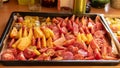 Tray with sliced tomatoes, different colors and shapes, autumn harvest