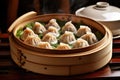 tray of steamed dumplings in bamboo steamer