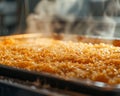 A tray of sweet rice concoction bakes to a golden crunch, the fumes hinting at the delight to come Royalty Free Stock Photo