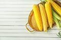 Tray with tasty corn cobs on wooden background Royalty Free Stock Photo