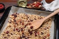 Tray with tasty granola, nuts and dry fruits on wooden table, closeup