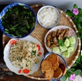 Tray of Vietnamese vegetarian meal for lunch time, leaf mustard soup, fried cabbage, vegan meat