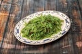 Tray of wakame seaweed salad with cayenne and sesame seeds