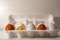 A tray with white and brown, chicken eggs, and a yellow toy chicken. Royalty Free Stock Photo