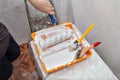 Tray with white paint and painting tools, roller and brushes. Royalty Free Stock Photo