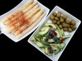 Trays with seasoned asparagus, avocados and olives