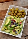 Trays with seasoned asparagus, avocados and olives