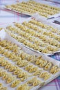 Trays of vegetarian italian tortelli, vertical