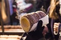 Trdelnik bakery in girl hands on the street market in Prague, Czech Republic. Czech sweetness.