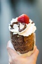 Trdelnik or trdlo is traditional Czech sweet. Woman hand keep trdlo in Prague street. Street food.