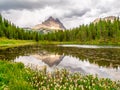 Tre Cime di Lavaredo, aka Drei Zinnen, reflection in water of Antorno Lake with dramatic stormy sky, Dolomites, Italy Royalty Free Stock Photo