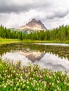 Tre Cime di Lavaredo, aka Drei Zinnen, reflection in water of Antorno Lake with dramatic stormy sky, Dolomites, Italy Royalty Free Stock Photo