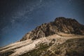 Tre Cime Dolomiti and night sky with galaxy