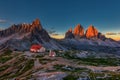 Tre Cime and rifugio hut at sunrise in summer in Dolomites, Italy