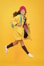 Tread on air. Active small child rush to school on yellow background. Happy girl enjoy active lifestyle. Little