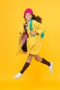Tread on air. Active small child rush to school on yellow background. Happy girl enjoy active lifestyle. Little Royalty Free Stock Photo