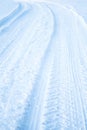 Tread texture car wheels on snow. Winter road in January, December. Rural area and background of tractor tracks in the snow Royalty Free Stock Photo