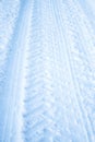 Tread texture car wheels on snow. Winter road in January, December. Rural area and background of tractor tracks in the snow Royalty Free Stock Photo