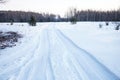 Tread texture of car wheels snow. Winter road in January, December. Rural area and background of tractor tracks in the snow Royalty Free Stock Photo