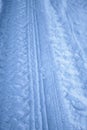 Tread texture of car wheels on snow. Winter road in January, December. Rural area and background of tractor tracks in the snow Royalty Free Stock Photo