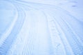 Tread texture of car wheels snow. Winter road in January, December. Rural area and background of tractor tracks in the snow Royalty Free Stock Photo