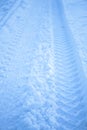 Tread texture of car wheels on snow. Winter road in January, December. Rural area and background of tractor tracks in the snow Royalty Free Stock Photo