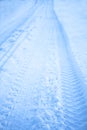 Tread texture of car wheels on snow. Winter road in January, December. Rural area and background of tractor tracks in the snow Royalty Free Stock Photo