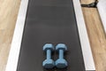 A treadmill with blue handweights on it ready for an exercise or workout routine Royalty Free Stock Photo