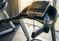 A treadmill inside a well-lit gym features a digital control panel Royalty Free Stock Photo