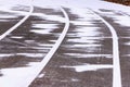 Treadmill, paved, with markings for runner athletes. In winter in snowy weathe